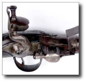Flash pan with silver knob showing the rotating cylinder and touch hole