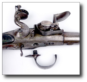 Pistol with trigger guard removed showing the chamber behind the first ball